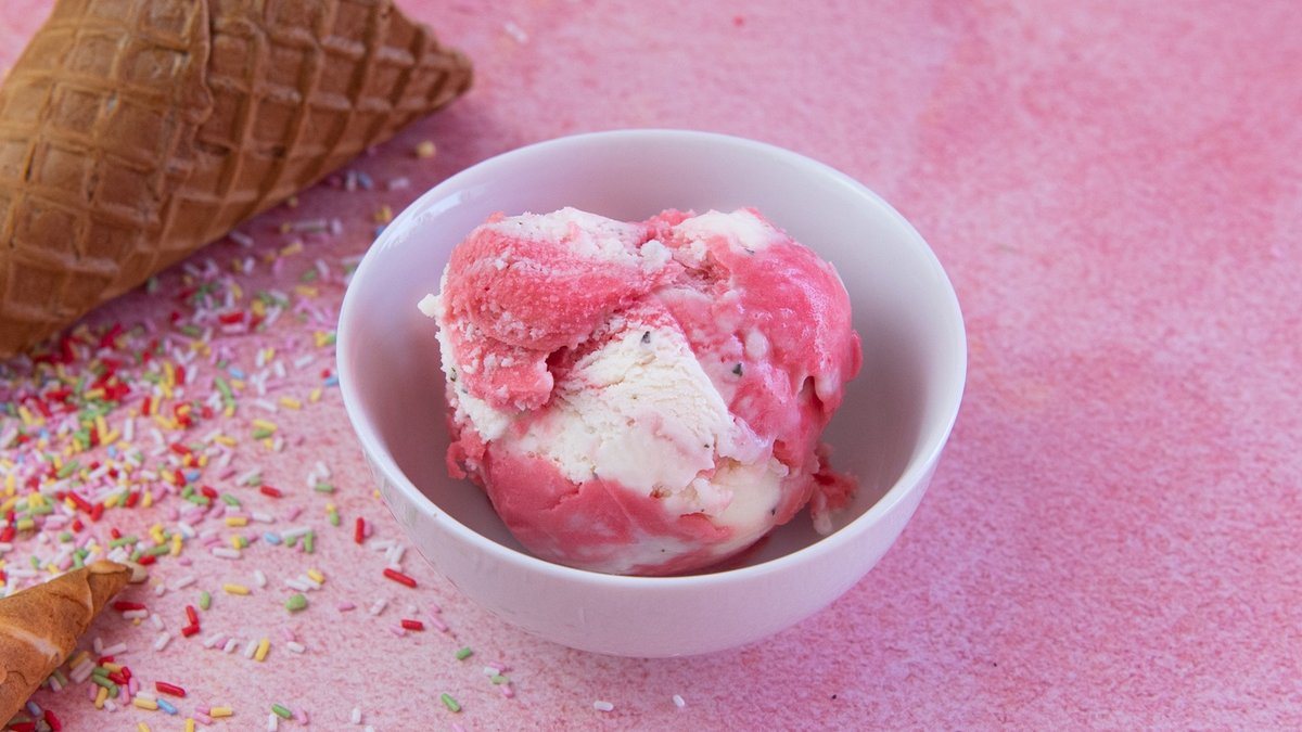 Two scoops of Gelato Mio ice cream in a cup with a classic cone